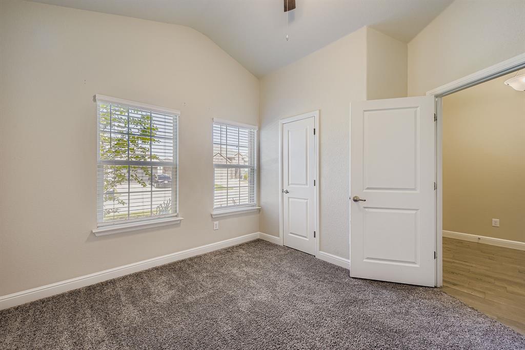 1829 Ruffian Road Granbury, TX 76049 - Photo 7 of 39 a view of an empty room with window and hardwood floor