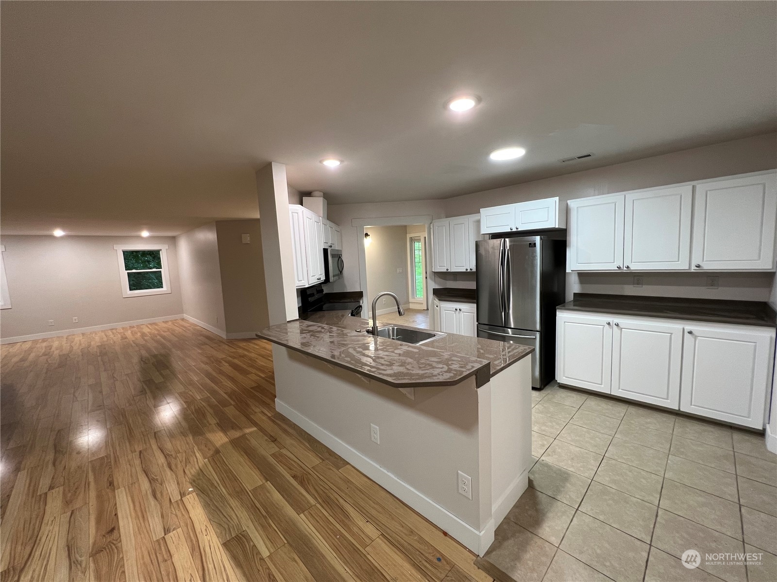 8229 South 132nd Street Seattle, WA 98178 - Photo 3 of 15 a kitchen with stainless steel appliances granite countertop a sink and cabinets