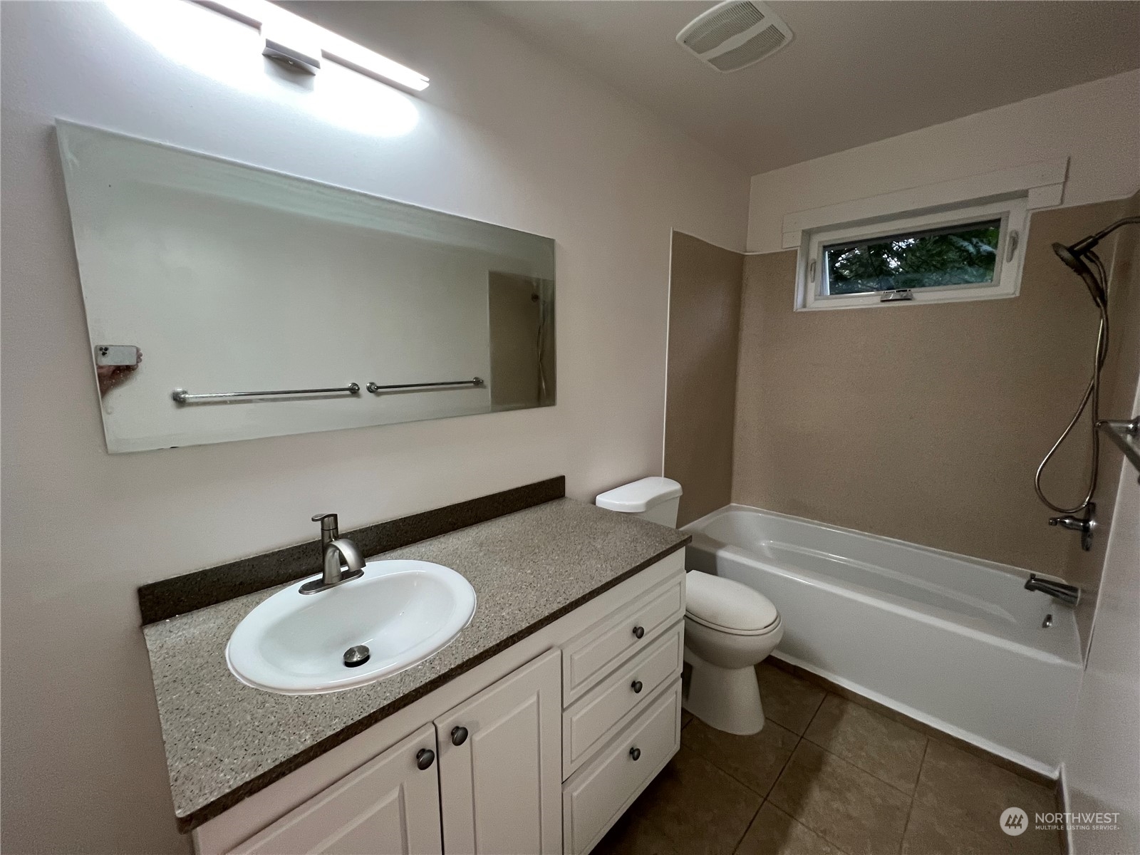 8229 South 132nd Street Seattle, WA 98178 - Photo 10 of 15 a bathroom with a sink toilet a mirror and shower