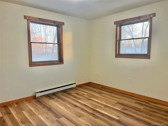 wooden floor in an empty room with a window