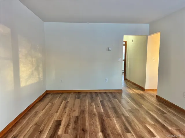 a view of a room with wooden floor