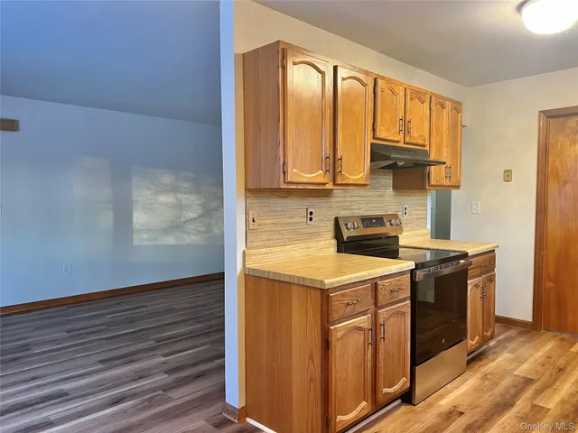 a kitchen with stainless steel appliances granite countertop a stove and a sink