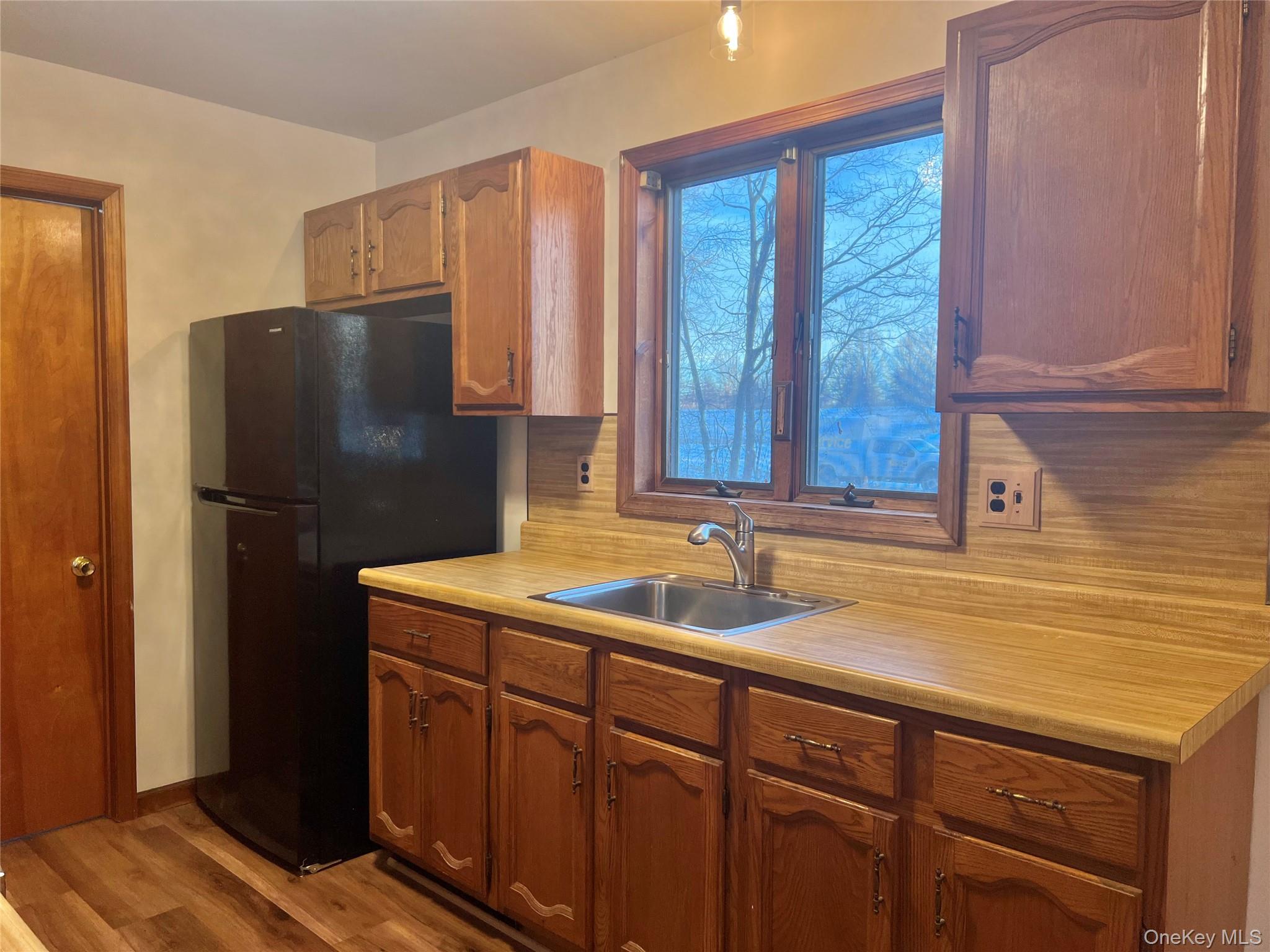 188 River Road, Unit B Wallkill, NY 12589 - Photo 7 of 20 a kitchen with a sink and a refrigerator