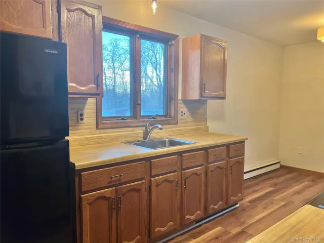 a bathroom with a sink a mirror and a window
