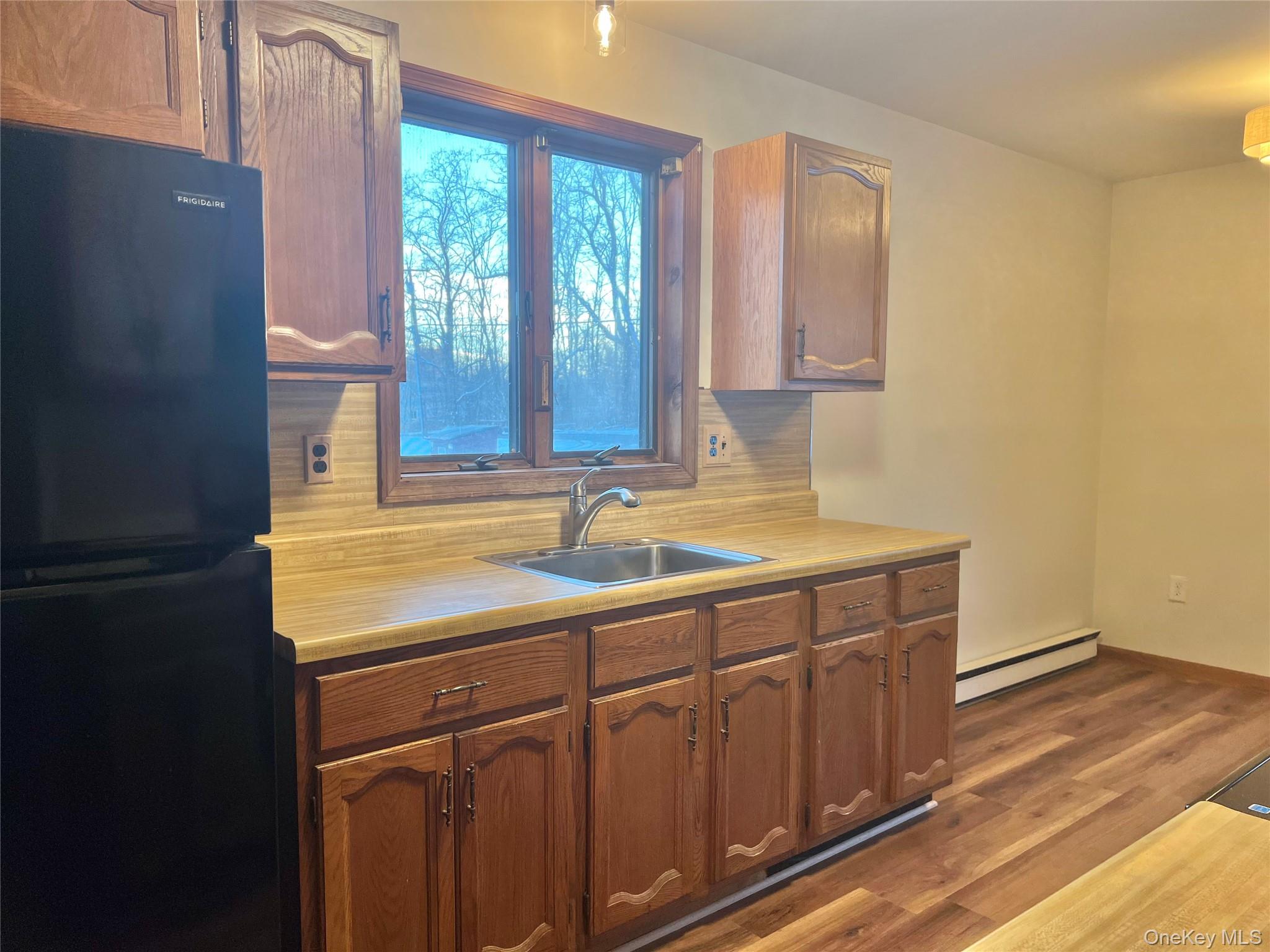 188 River Road, Unit B Wallkill, NY 12589 - Photo 8 of 20 a bathroom with a sink a mirror and a window