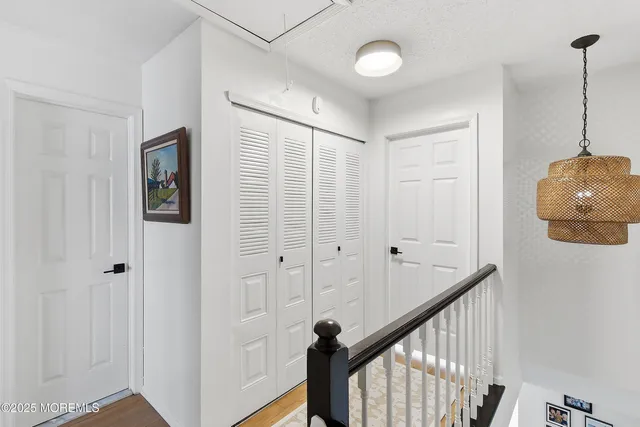a bedroom with furniture and a large window