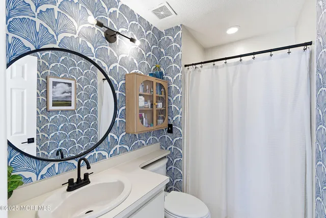 a bedroom with furniture and a flat screen tv