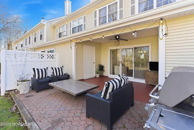a view of a patio with a table and chairs