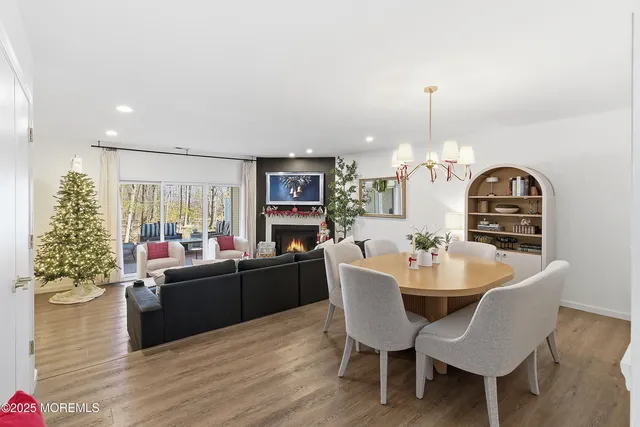 a view of a dining room with furniture and chandelier