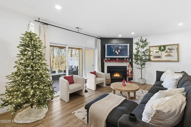 a living room with furniture a fireplace and a flat screen tv