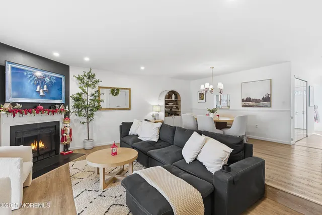 a living room with furniture and a chandelier