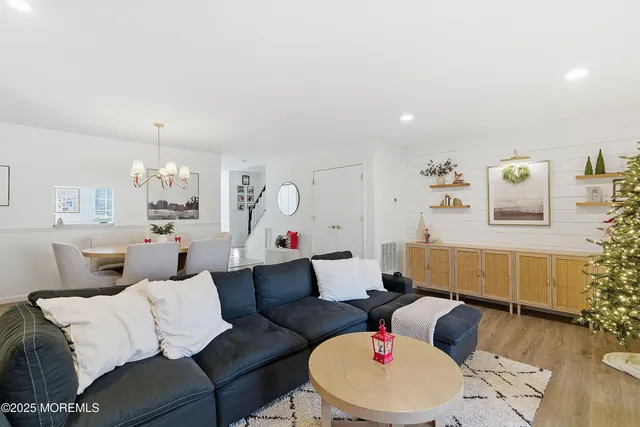 a kitchen with stainless steel appliances granite countertop a sink a stove a refrigerator a microwave oven with a dining table and chairs