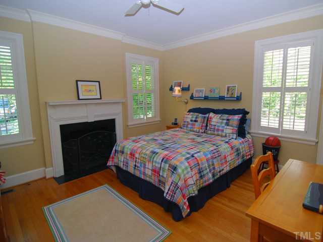 1628 Oberlin Road Raleigh, NC 27608 - Photo 8 of 12 The first floor bedroom suite is tucked away from the living areas, and can be either the master or a guest suite. West-facing with windows on 3 sides and the charming fireplace, a quiet retreat.