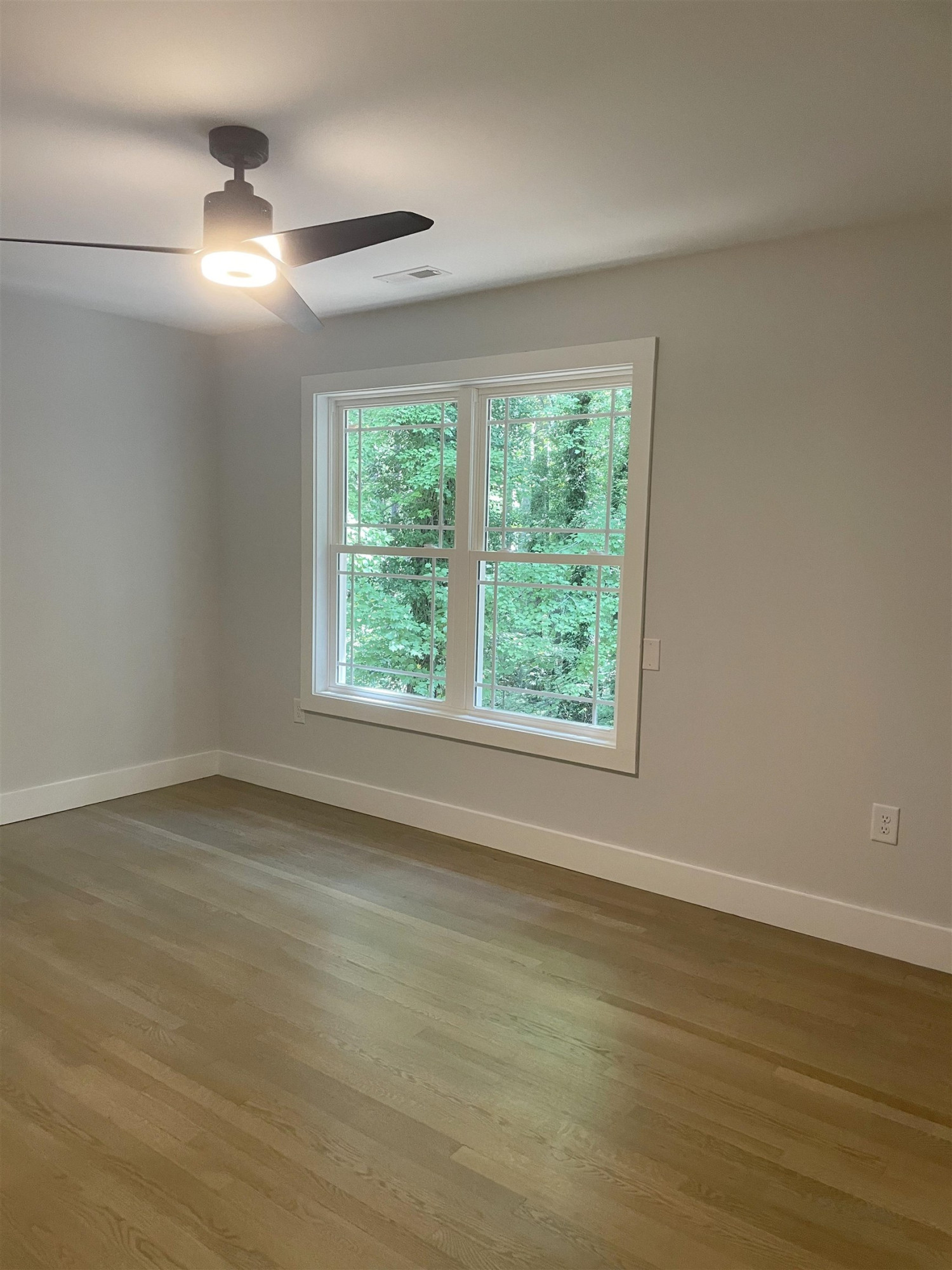 245 Marilyn Circle Cary, NC 27513 - Photo 15 of 21 an empty room with wooden floor and windows