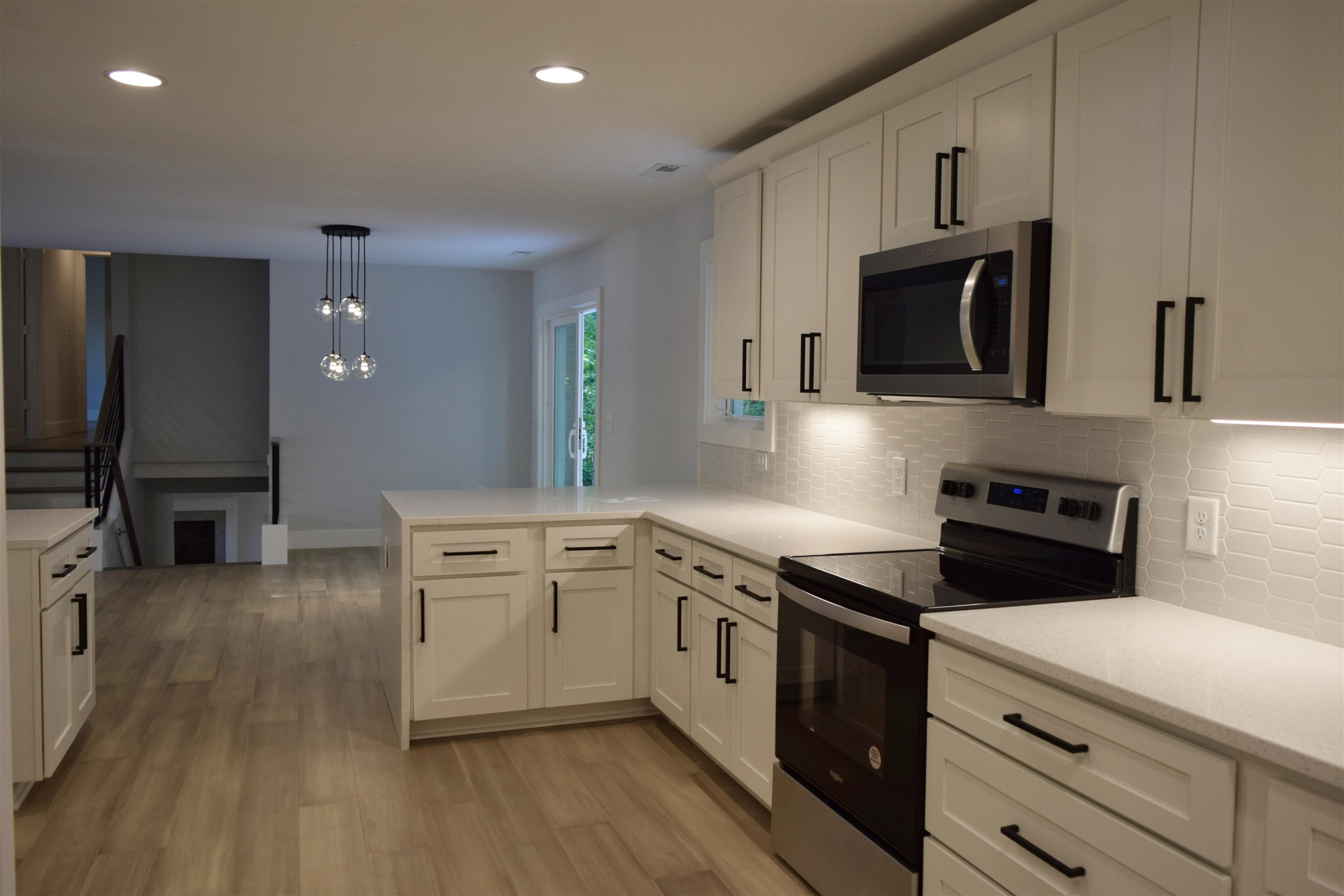 245 Marilyn Circle Cary, NC 27513 - Photo 9 of 21 a kitchen with stainless steel appliances a stove microwave and sink