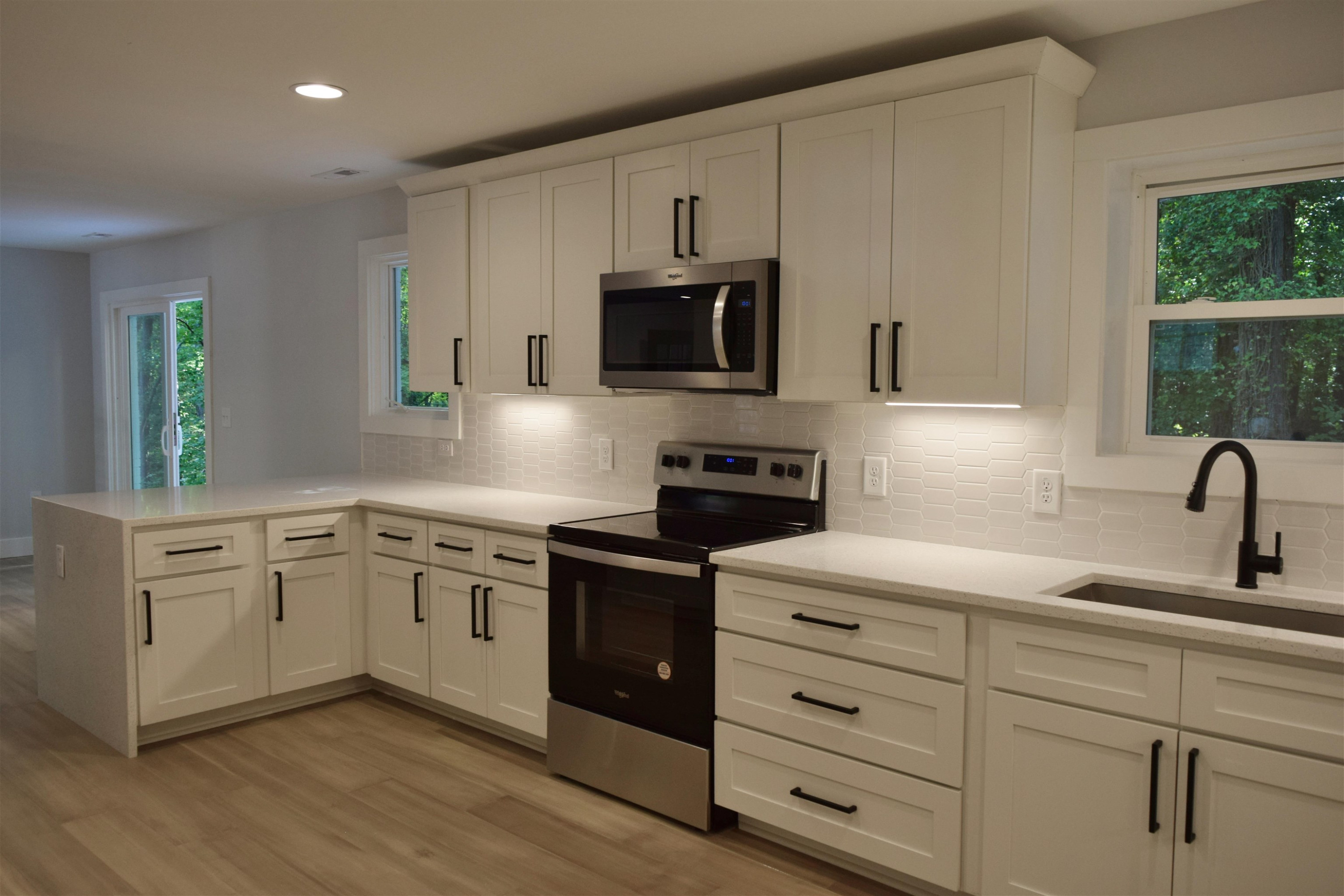 245 Marilyn Circle Cary, NC 27513 - Photo 10 of 21 a kitchen with white cabinets and stainless steel appliances
