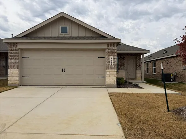 a front view of a house with garage