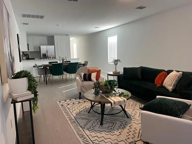 a living room with furniture and wooden floor
