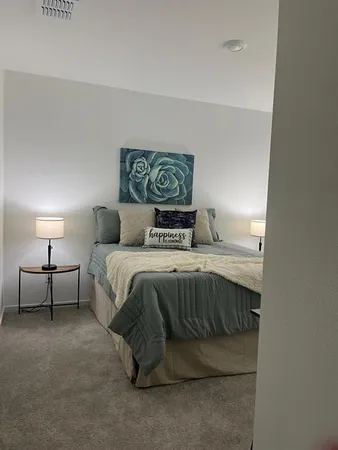 a bedroom with a bed and a lamp