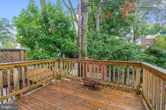 a balcony with wooden floor and fence