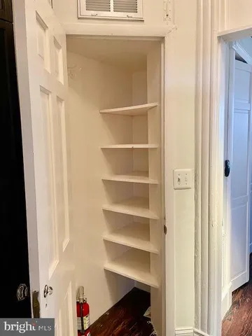 a view of walk in closet with empty racks