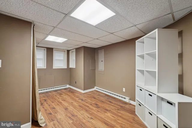 a view of an empty room with wooden floor