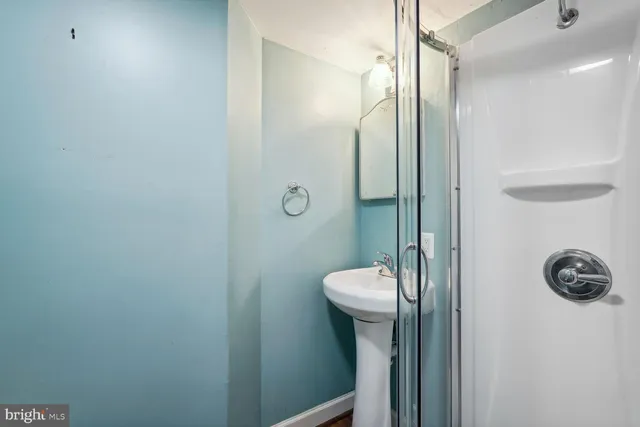 a bathroom with a shower a toilet and sink