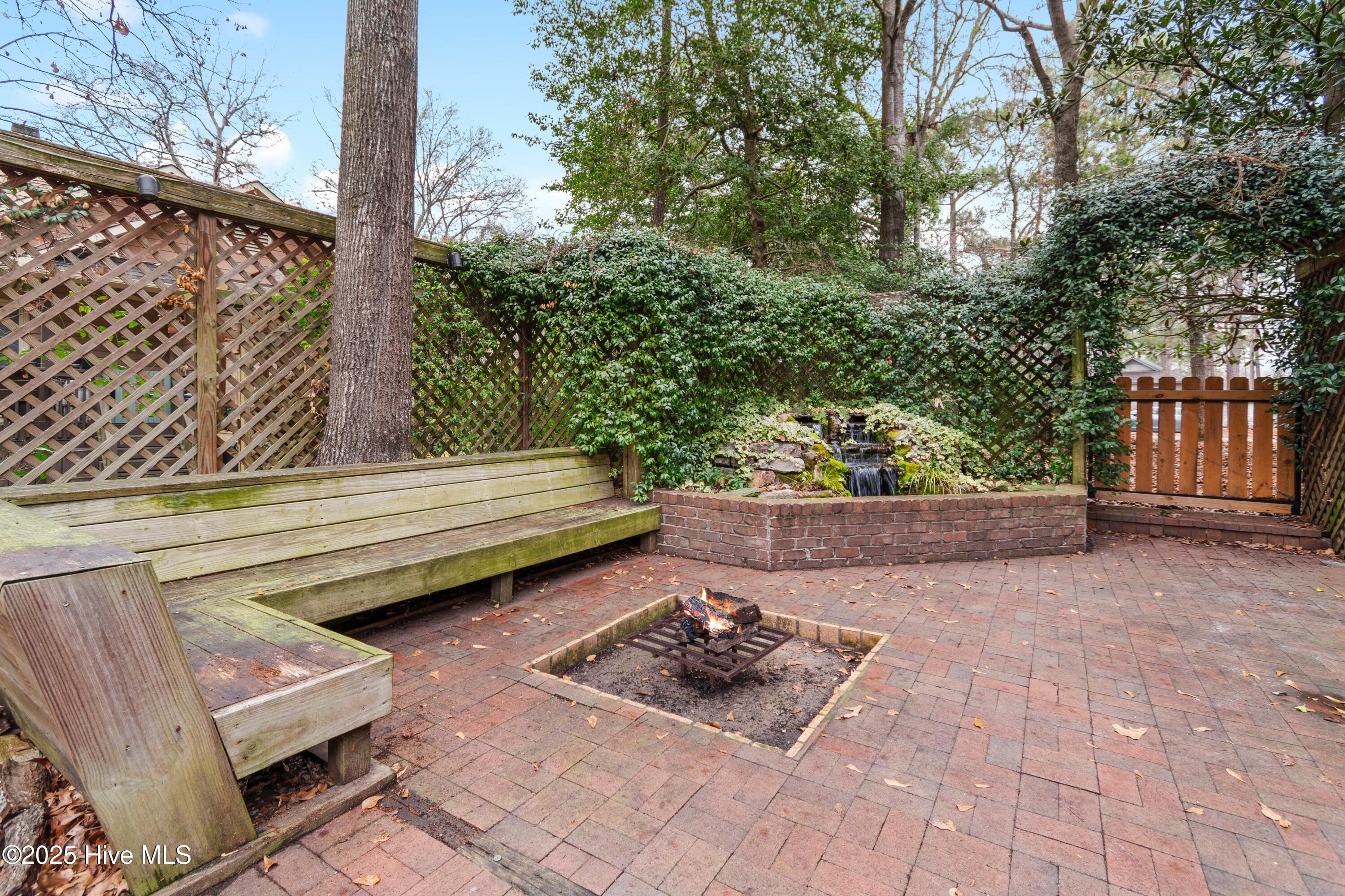 103 Ridge Road Hampstead, NC 28443 - Photo 16 of 60 Fountain, Firepit and Built In Benches!