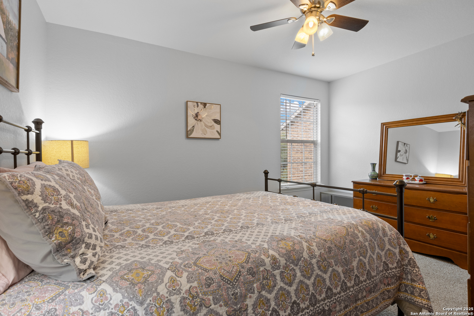 512 Granite Mist Universal City, TX 78148 - Photo 13 of 16 a bedroom with a bed and a chandelier