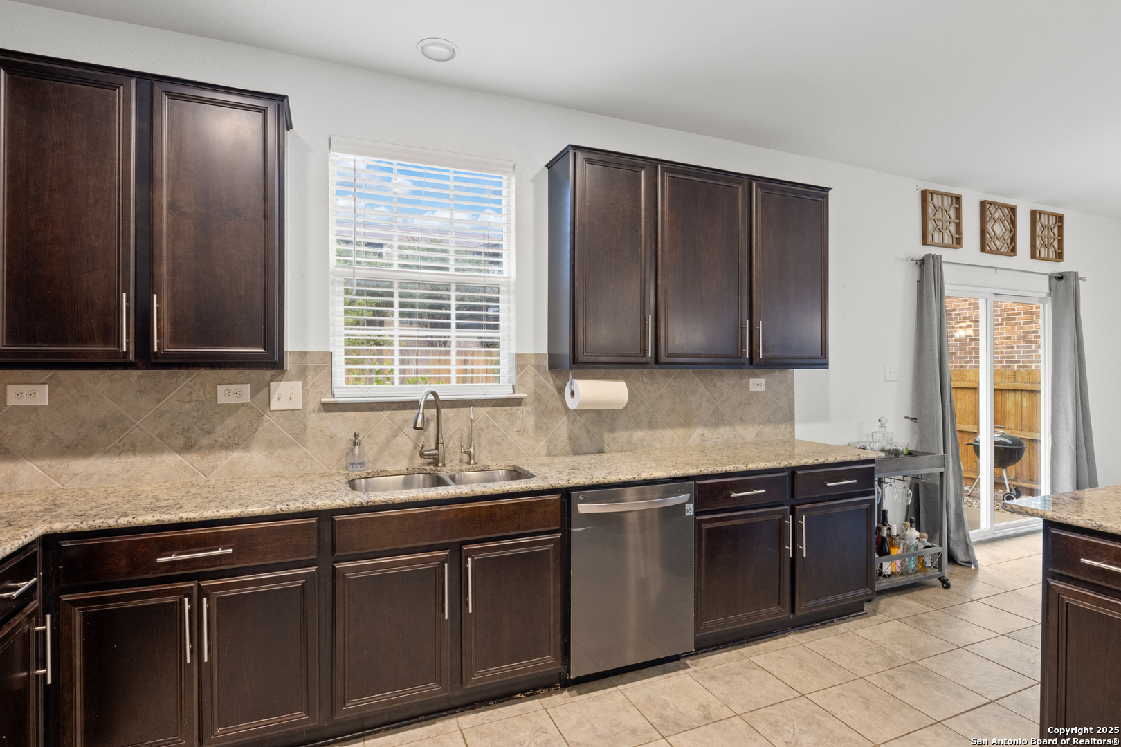 512 Granite Mist Universal City, TX 78148 - Photo 6 of 16 a kitchen with stainless steel appliances granite countertop a sink and a microwave