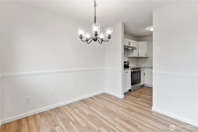 a view of a kitchen with wooden floor and a kitchen