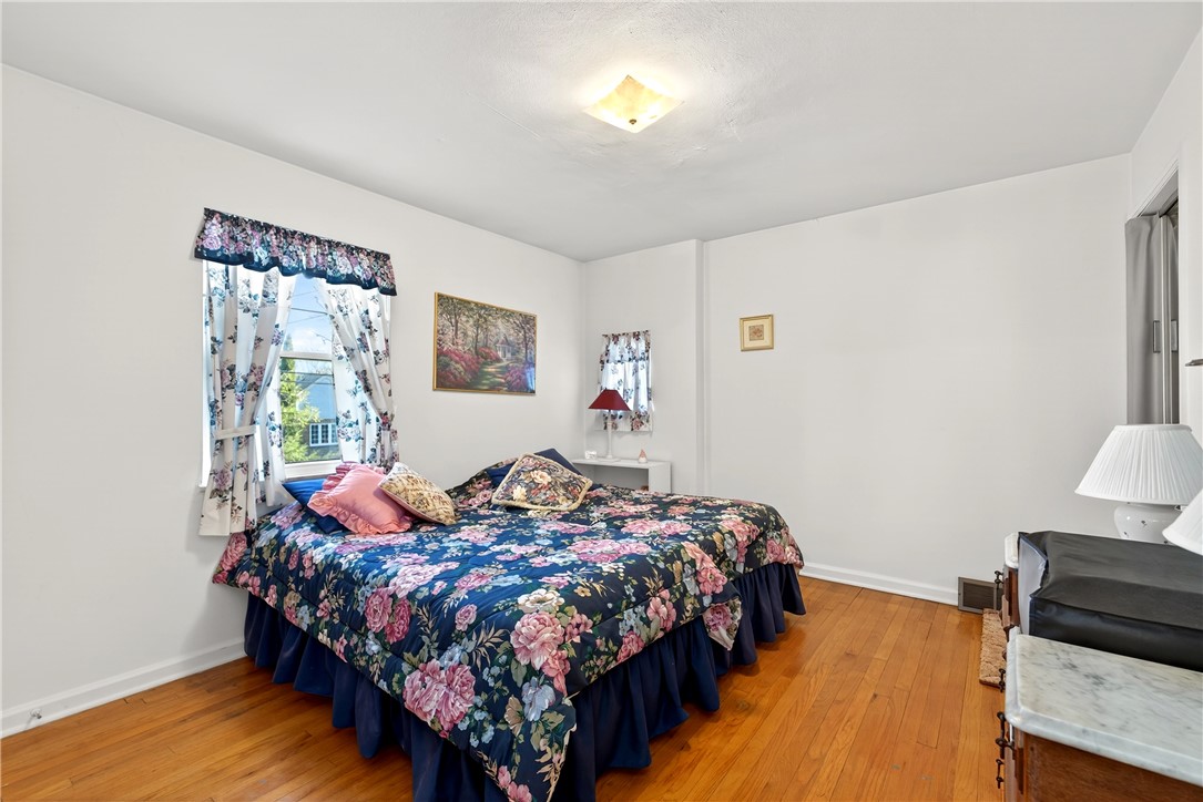 1237 Laurelwood Road Dayton, OH 45409 - Photo 22 of 56 This cozy bedroom features warm hardwood flooring, inviting natural light, and classic architectural elements.