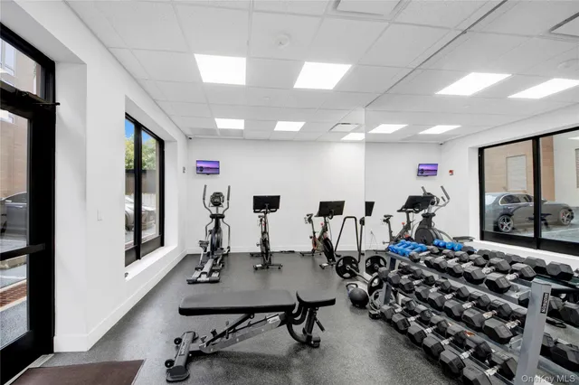a room with gym equipment and a large window