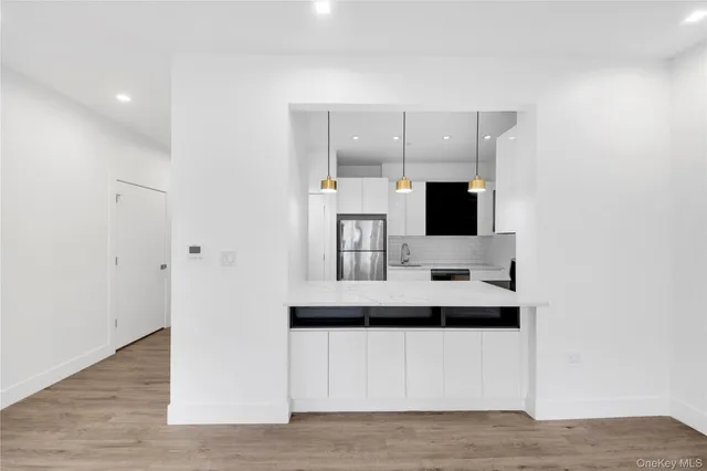 a kitchen with a sink a microwave a stove and refrigerator