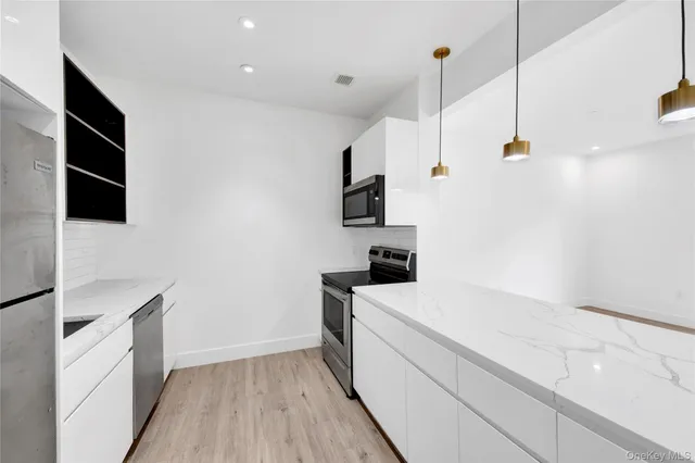 a white refrigerator freezer sitting in a kitchen
