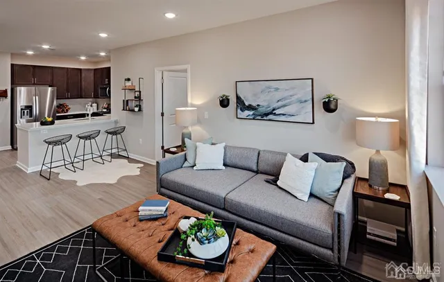 a living room with furniture and kitchen view