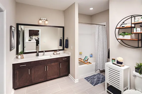 a bathroom with a sink a mirror and a bathtub