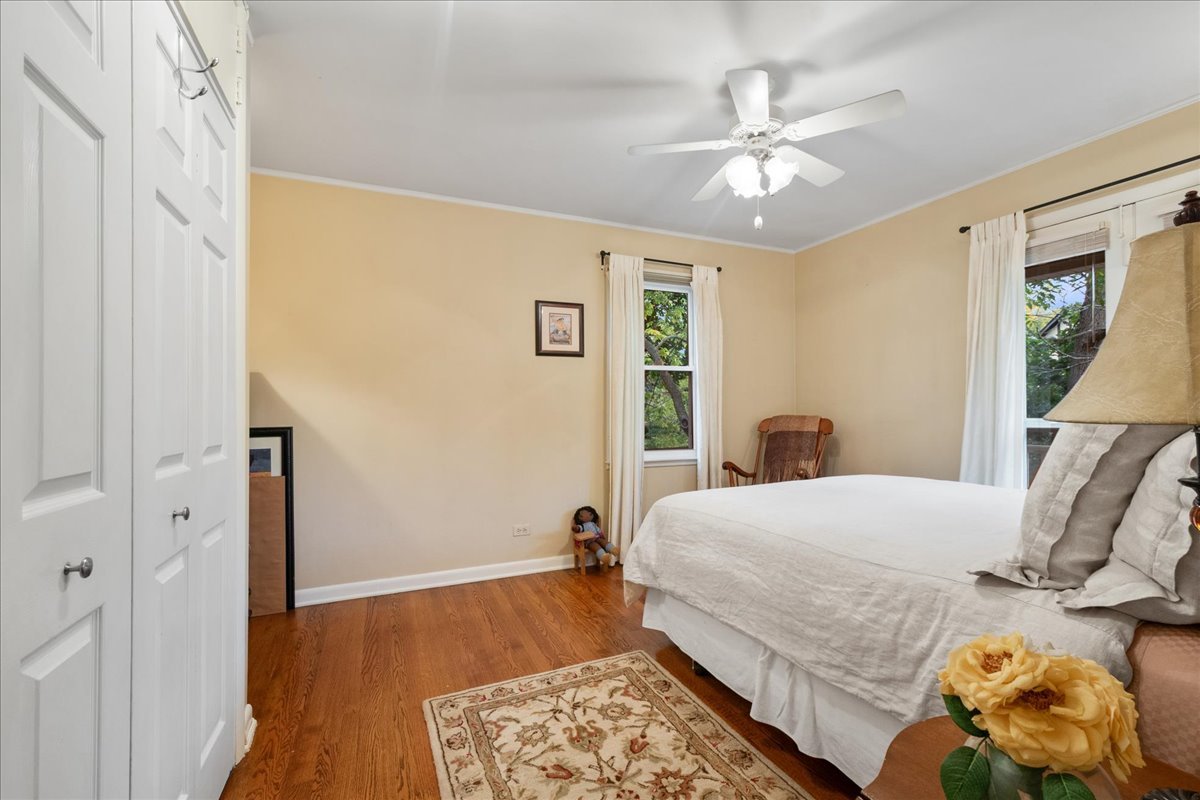 2440 Simpson Street Evanston, IL 60201 - Photo 21 of 34 a bedroom with a bed and wooden floor