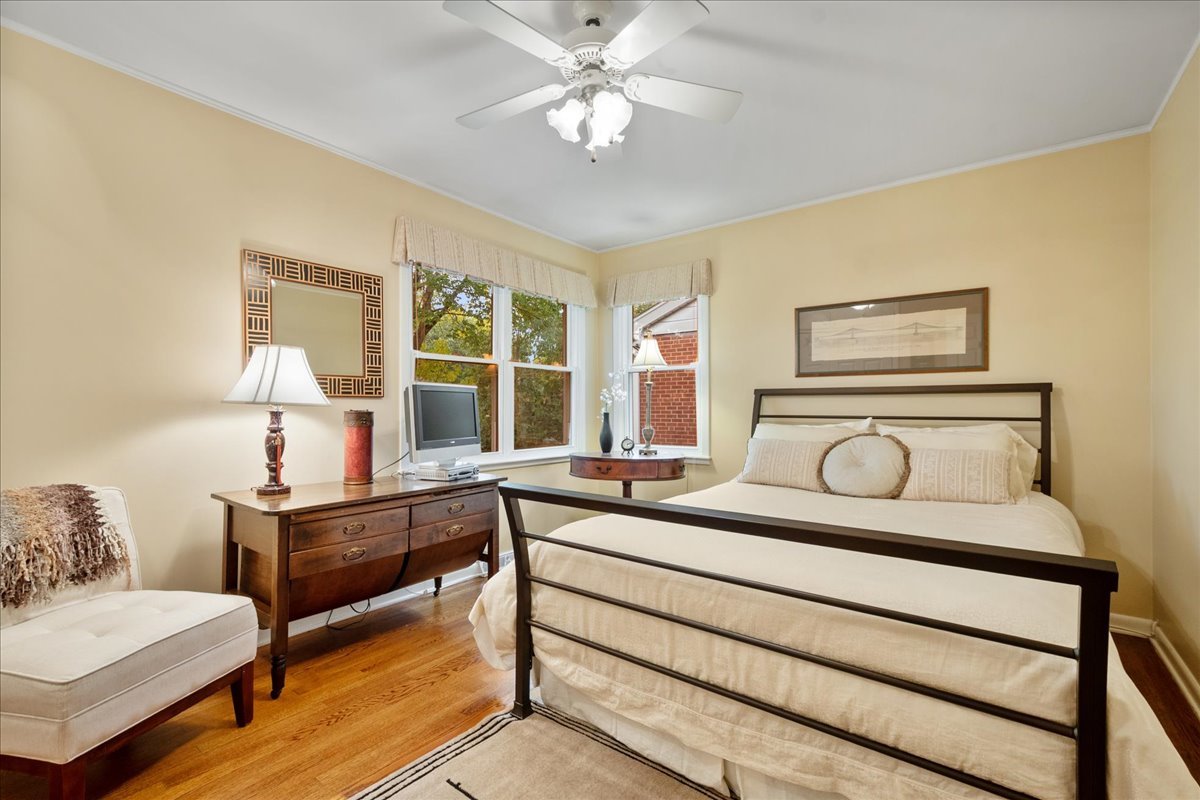 2440 Simpson Street Evanston, IL 60201 - Photo 24 of 34 a bedroom with a bed and a chandelier