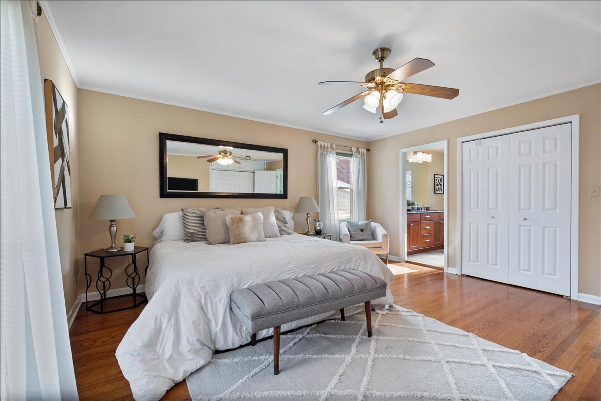 2440 Simpson Street Evanston, IL 60201 - Photo 29 of 34 a bedroom with a bed and a chandelier