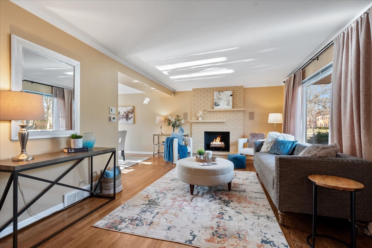 2440 Simpson Street Evanston, IL 60201 - Photo 3 of 34 a living room with furniture a rug a fireplace and a large window