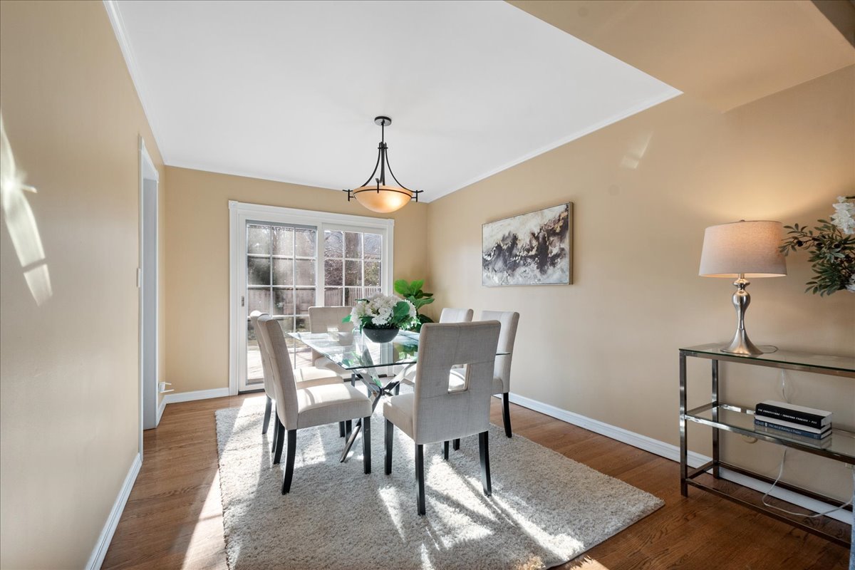 2440 Simpson Street Evanston, IL 60201 - Photo 8 of 34 a view of a dining room with furniture window and wooden floor