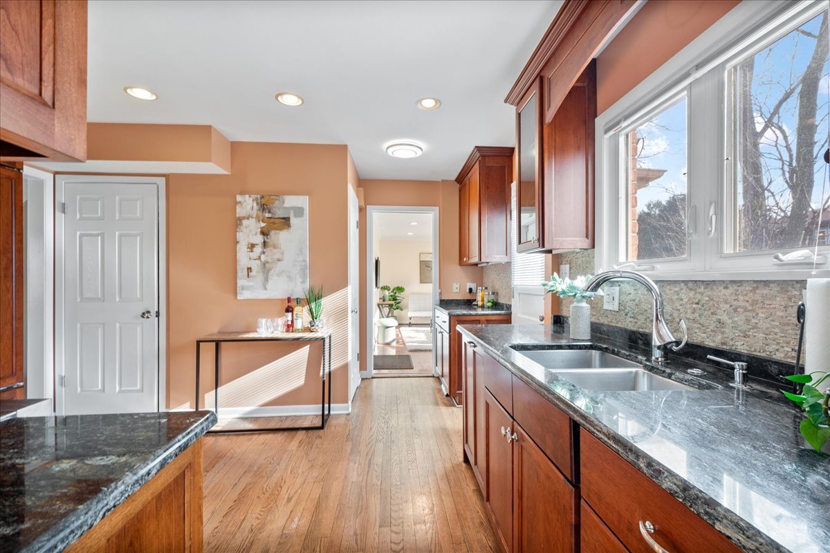 2440 Simpson Street Evanston, IL 60201 - Photo 10 of 34 a kitchen with stainless steel appliances granite countertop a sink stove and cabinets