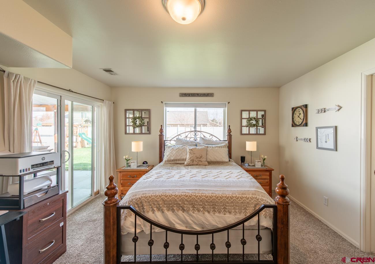 111 6675th Road Montrose, CO 81401 - Photo 16 of 40 a bedroom with a bed a table and chairs