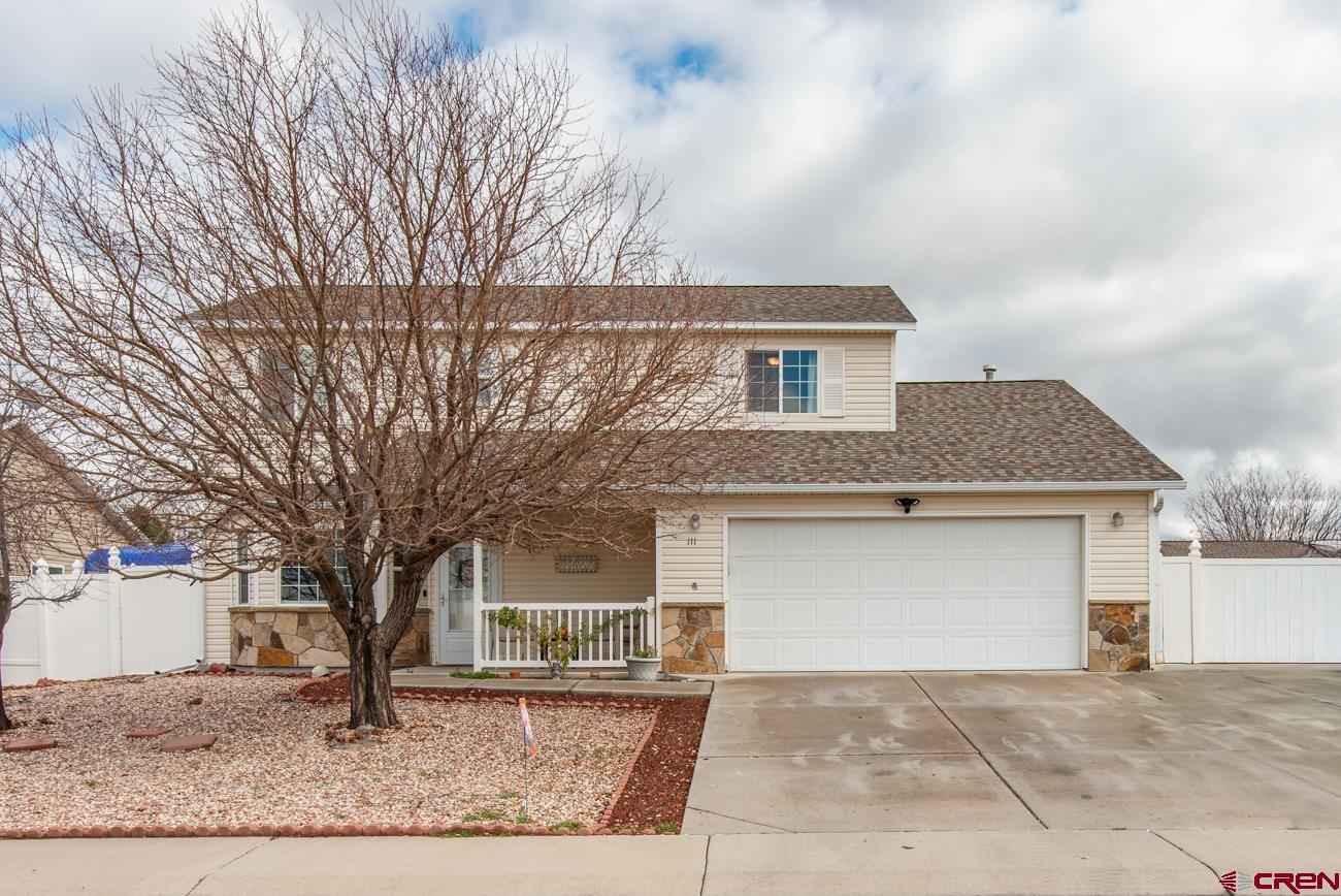 111 6675th Road Montrose, CO 81401 - Photo 2 of 40 a front view of a house with garden