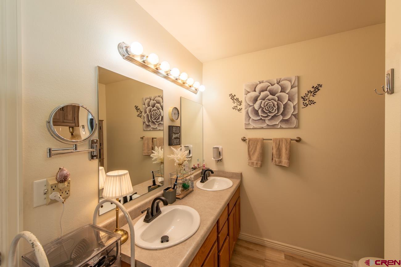 111 6675th Road Montrose, CO 81401 - Photo 21 of 40 a bathroom with a sink mirror vanity and toilet