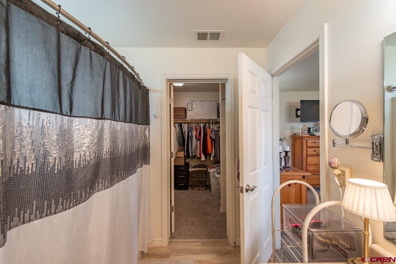 111 6675th Road Montrose, CO 81401 - Photo 22 of 40 a view of a hallway with wooden furniture and windows