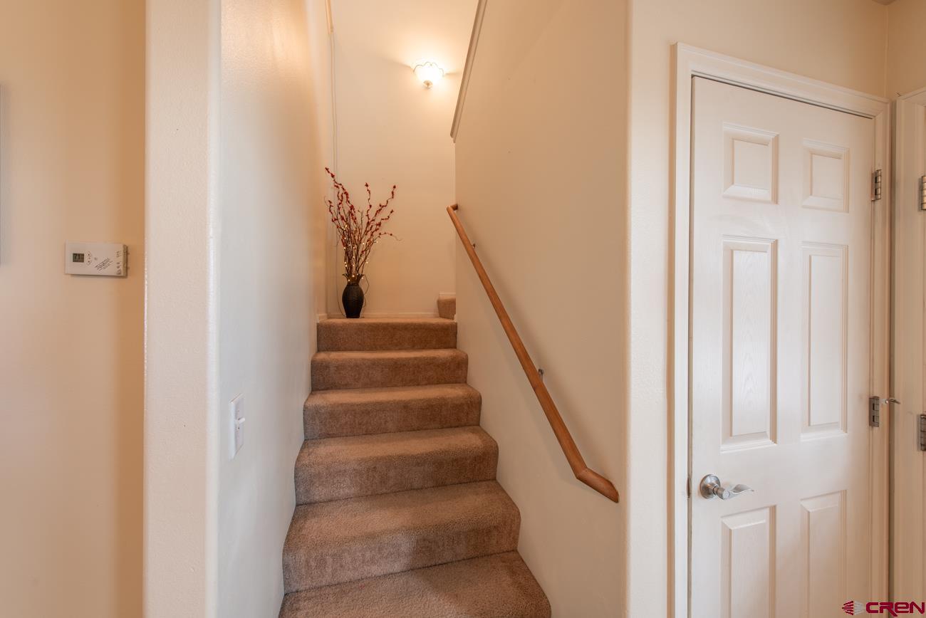 111 6675th Road Montrose, CO 81401 - Photo 24 of 40 a view of staircase with white walls and a window