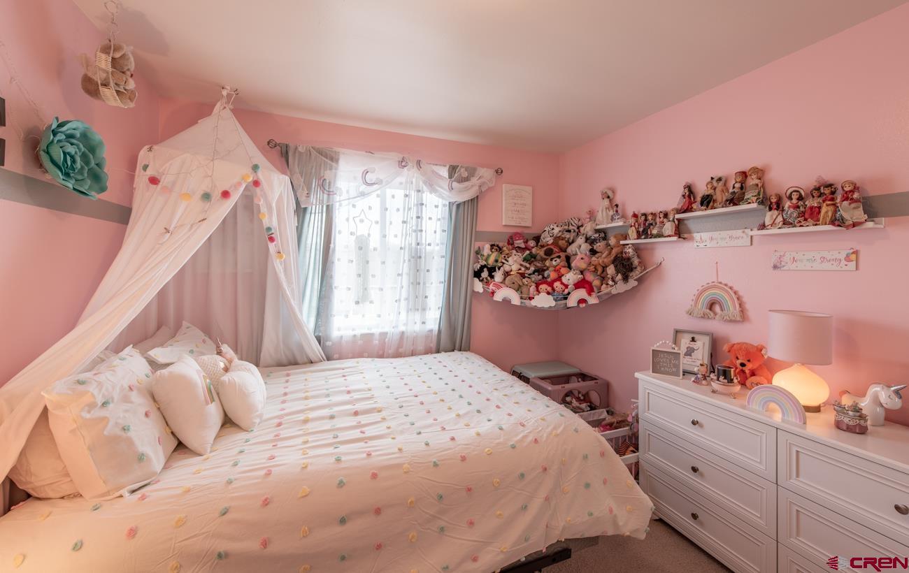 111 6675th Road Montrose, CO 81401 - Photo 30 of 40 a bedroom with a bed and a window