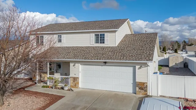 a front view of a house with a garden and sitting area